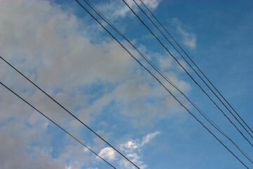 wires against a cloudy summer sky