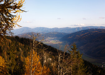 beautiful day in the austrian mountains with colorful trees and clouds