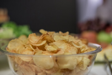 Porção de batatas fritas em vasilha de vidro em buffet.
