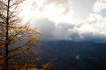 beautiful day in the austrian mountains with colorful trees and clouds