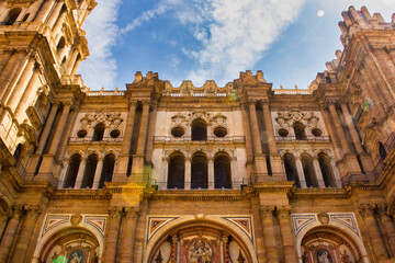 Fototapeta na wymiar Malaga, Spain - September 03, 2015: Main city center view of tourist attraction european architecture under dramatic blue sky