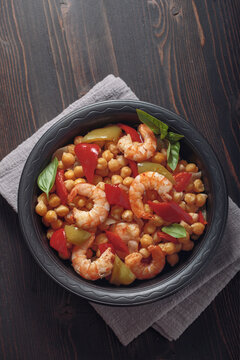 Shrimp with chickpea and pepper stew on table, top view