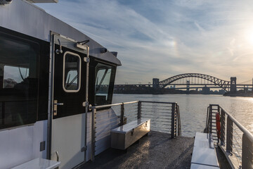 view of a bridge in the background from a boat on a sunset