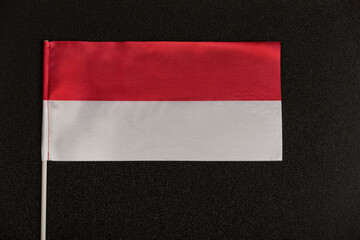 Table flag of Poland on a black background. Red-white flag.