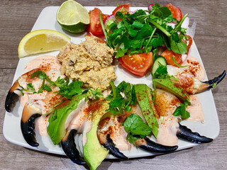 Deluxe crab salad of crab claws and mixed crab meat, avocado and lemon wedge