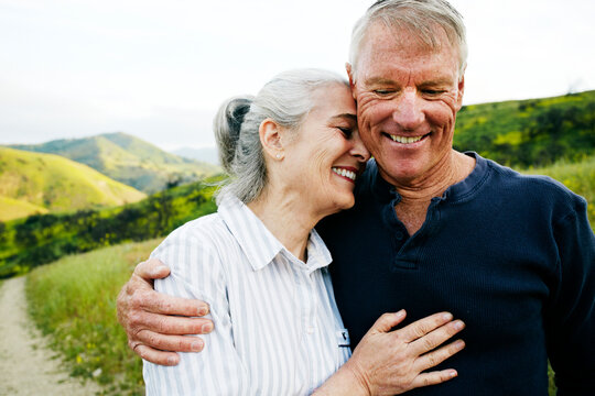 Caucasian couple hugging on hiking trail