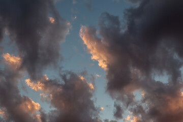 Background of the evening sky with dark gray and Golden clouds