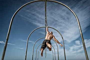 Man exercising on gymnastics rings