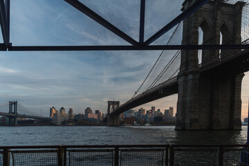 view of a bridge over the water in a city from an underpass