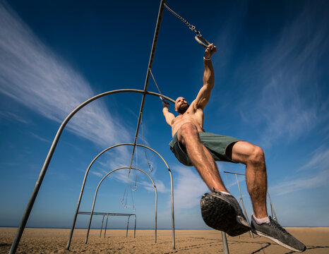Man exercising on gymnastics rings