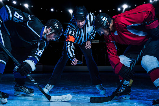 Hockey players and referee starting match