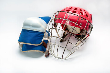 Hockey gloves,helmet and puck lay a white background isolated