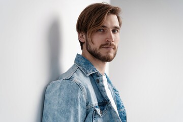Obraz premium Fashion portrait of young man wearing jeans jacket