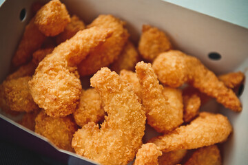 Fried shrimps in white striped fast food box