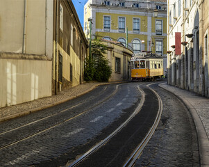 Naklejka na ściany i meble Vintage yellow tram in the city center of Lisbon, Portugal.