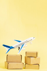 Airplane and stack of cardboard boxes. concept of air cargo and parcels, airmail. Fast delivery of goods and products. Cargo aircraft. Logistics, connection to hard-to-reach places. Banner, copy space