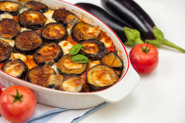 Homemade Parmigiana - Italian food: baked eggplants, moth tomato sauce and mozzarella and parmesan cheese. Copy space.