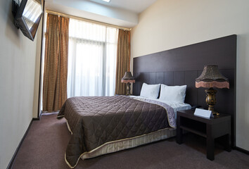 Hotel room interior with double bed furniture. Interior of modern bedroom
