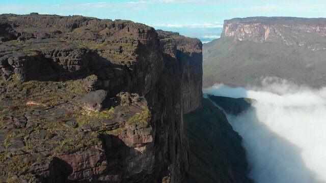 The Rocky Mountain Landscape Of Mount Roraima With Low Lying Clouds On A Sunny Day In Venezuela. Plateaus In South America.  - aerial drone