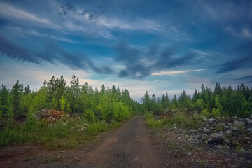 Fototapeta na wymiar Majestic sunset in the mountains forest. Dramatic sky. Ural mountains.