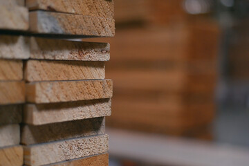 Timber Flooring Factory. Pile of cut wood in factory storage warehouse. Lumber in warehouse.