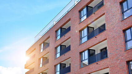 Modern apartment buildings on a sunny day with a blue sky. Facade of a modern apartment building. Glass surface with sunlight.