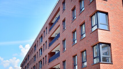 Modern apartment buildings on a sunny day with a blue sky. Facade of a modern apartment building. Glass surface with sunlight.