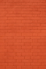 brick wall of bricks painted with bright red paint as the background