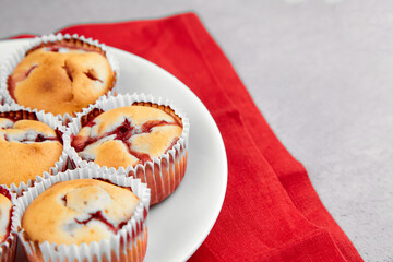 Strawberry muffin dessert on red linen napkin background