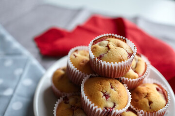 White plate with strawberry muffins on linen napkin background