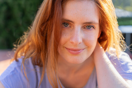 Portrait of redheaded woman looking at camera