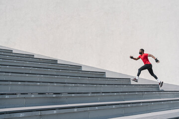 Sportsman wearing face mask running up stairs