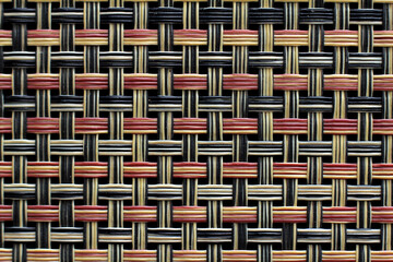 Plastic weft texture close-up in red, black and natural