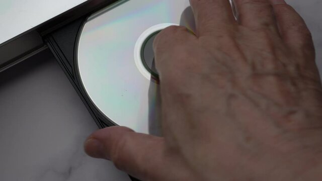 Top View DVD Disc, Eject Tray And Extract Disc In DVD-player. Man Of Hand Remove Disc From The Device DVD/CD Player. 
