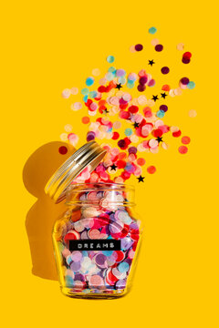 Colorful confetti spilling from glass jar