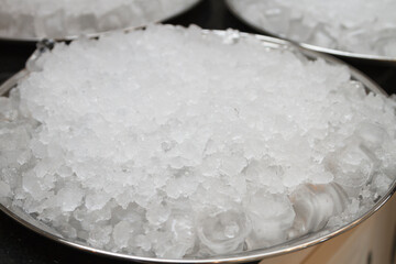 Crushed ice in a metal bowl.