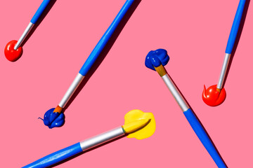 Close up of paintbrushes in blob of oil paints