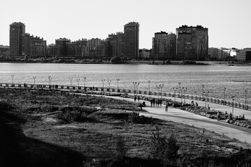 Fototapeta premium Cityscape in faded black and white. Chest on the modern houses background. Urban image. Downtown of Kazan Russian city in. Monochrome. Touristic destination. Retro style of landscape photography.