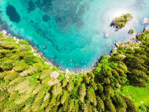 Italy, Province of Udine, Tarvisio, Drone view of turquoise Fusine Lake