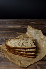 Freshly baked slice of bread sliced ​​on wrapping paper.