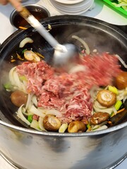 Stirring traditional hot pot in Taiwan