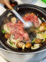Stirring traditional hot pot in Taiwan