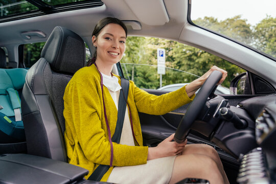 Portrait of smiling car driver with protective mask