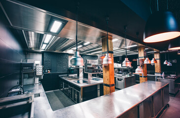 Interior of illuminated commercial kitchen in restaurant