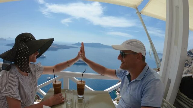 Couple having dinner on the background of the sea in Santorini, greece