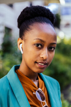Portrait of young businesswoman with earpods