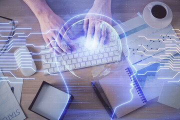 Double exposure of man's hands typing over computer keyboard and brain hologram drawing. Top view....