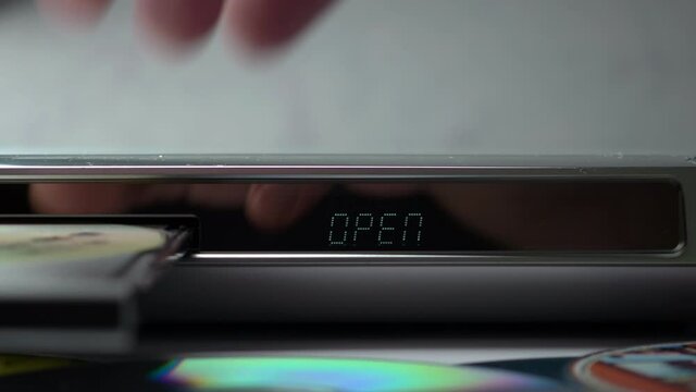 DVD Player Display. Eject Tray And Extract Disc In DVD-player. Male Hand Remove Disc From The Device DVD/CD Player. .