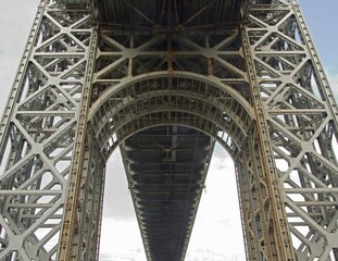 Fort Lee, NJ / United States - May 14, 2020: Vertical closeup of underneath the historic George Washington Bridge. The bridge is a double-decked suspension bridge spanning the Hudson River