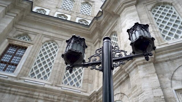 lamp in the garden of a mosque. historical mosque in the background. istanbul mosques close-up cinematic
